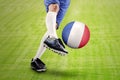 Soccer player kicking a ball at field Royalty Free Stock Photo