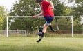 Soccer player kicks ball in a field Royalty Free Stock Photo