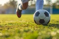 A soccer player dribbling and kicking a ball on a field Royalty Free Stock Photo