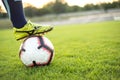 soccer player in leggings. Close-up photo with the ball on the green grass of a football field. Outdoors Royalty Free Stock Photo