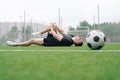 Soccer player A man holds his knee. Dislocation of the knee joint. The concept of falling during sports