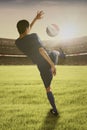 Soccer player playing a ball at field Royalty Free Stock Photo