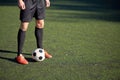 Soccer player playing with ball on football field Royalty Free Stock Photo