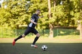 Soccer player playing with ball on football field Royalty Free Stock Photo