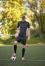 Soccer player playing with ball on football field Royalty Free Stock Photo