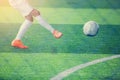 Soccer player put orange sport shoes shoot ball Royalty Free Stock Photo