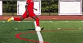 Soccer player in red uniform about to kick the ball Royalty Free Stock Photo