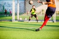 Soccer player run to shoot ball at penalty kick to goal with blurry goalkeeper background Royalty Free Stock Photo