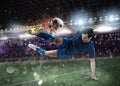 Soccer player with soccerball on fire at the stadium during the match. Royalty Free Stock Photo
