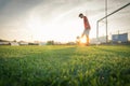 Soccer player is training alone at the stadium at sunset - Concept about soccer, sport, and lifestyle Royalty Free Stock Photo