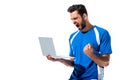 Soccer player using laptop and cheering