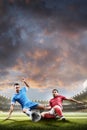 Soccer players in action on sunset stadium background Royalty Free Stock Photo