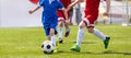 Soccer Players in a Duel. Elementary Age Kids in Soccer Clubs of Soccer Academies Royalty Free Stock Photo