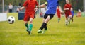 Soccer players duel. Soccer youth tournament game. Footballers compete for a soccer ball Royalty Free Stock Photo