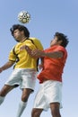 Soccer Players Heading Ball Against Blue Sky Royalty Free Stock Photo