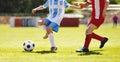 Soccer players in red and blue shirts at duel. Youth football tournament game Royalty Free Stock Photo