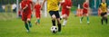 Soccer Players Run. Young Boys Running After Ball During Football Tournament Match
