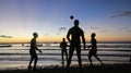 Soccer players silhouetted at sunset time at Ponta do Muta beach, near Barra Grande, Marau Peninsula, Bahia State, Brazil