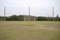 Soccer post with net with green grass and protective screens behind, Brazil, South America