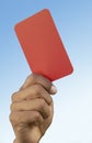 Soccer referee holding up red card close-up on hand