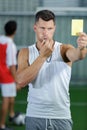 soccer referee showing yellow card to players during game Royalty Free Stock Photo