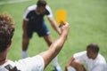 Soccer referee showing yellow card to players during game Royalty Free Stock Photo