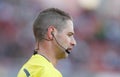 Soccer referee speaking with assistants during match