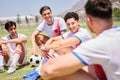 Soccer, relax and team on a football field talking, team building and laughing at a funny joke at training. Happy Royalty Free Stock Photo