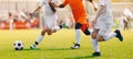 Soccer Shot. Young Boys Kicking Football Soccer Tournament Match on the Grass Pitch. Football Players Duel Royalty Free Stock Photo