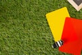 Soccer sports referee chrome whistle with game strategy drawing blackboard and yellow and red referee cards on grass background Royalty Free Stock Photo