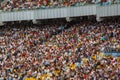 Soccer stadium inside view. football field, empty stands, a crowd of fans, a roof against the sky