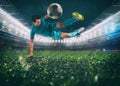 Soccer striker hits the ball with an acrobatic kick in the air at the stadium Royalty Free Stock Photo