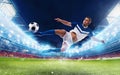 Soccer striker hits the ball with an acrobatic kick in a stadium Royalty Free Stock Photo