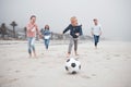 Soccer, summer beach activity and family running and playing with energy and happiness. Happy sea sport and football Royalty Free Stock Photo