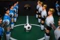 Soccer table game. Green field with blue and white plastic footballers Royalty Free Stock Photo