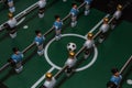 Soccer table game. Green field with blue and white plastic footballers Royalty Free Stock Photo