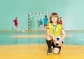 Soccer team captain standing on knee in futsal