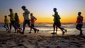 The soccer team training running outdoor under the beach sunset