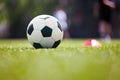 Soccer, training, and children on the sports field. Football equipment at sports grass pitch. Soccer ball and training cone marker Royalty Free Stock Photo