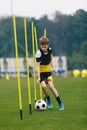 Soccer Training Drill For Youth Junior Player. Young Teenage Boy Running and Dribbling Ball Between Training Poles