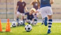 Soccer training practice. Player running with football ball in sports grass cleats