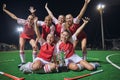 Soccer, trophy and women on a field at night to celebrate teamwork, winning and sports. Football, winner and portrait of