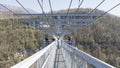 A long metal bridge and people walking, Sochi