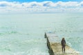 SOCHI,RUSSIA, 20 APRIL 2019 - lonely young girl standing on the breakwater