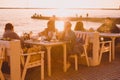 SOCHI,RUSSIA,  23 APRIL 2019 - people have dinner in a restaurant by the sea at sunset , blurred summer background Royalty Free Stock Photo