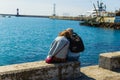 SOCHI,RUSSIA,23 APRIL 2019 - romantic couple sitting on the Black Sea beach, man and woman sitting back to the camera on the sea Royalty Free Stock Photo