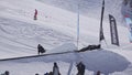 SOCHI, RUSSIA - APRIL 2, 2016: Snowboarder make backslide on rail on ski resort. Sunny day. Mountains. People.