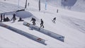 SOCHI, RUSSIA - APRIL 2, 2016: Snowboarder make backslide on rail. Ski resort. Sunny day. Mountains. People.