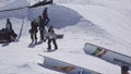 SOCHI, RUSSIA - APRIL 2, 2016: Snowboarder make backslide on rail on ski resort. Sunny. Mountains. Cameraman