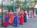 beautiful and happy women and girls are hare Krishna in bright dresses dancing and singing on the streets of Sochi in the summer